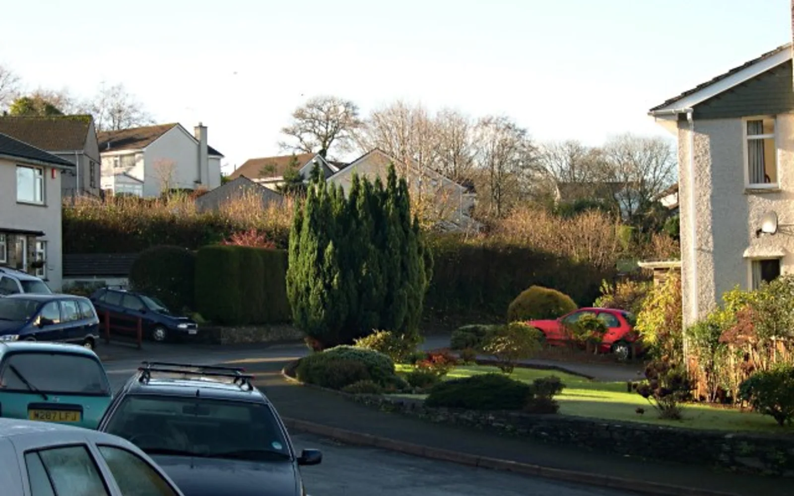 Row of suburban houses with driveways and gardens